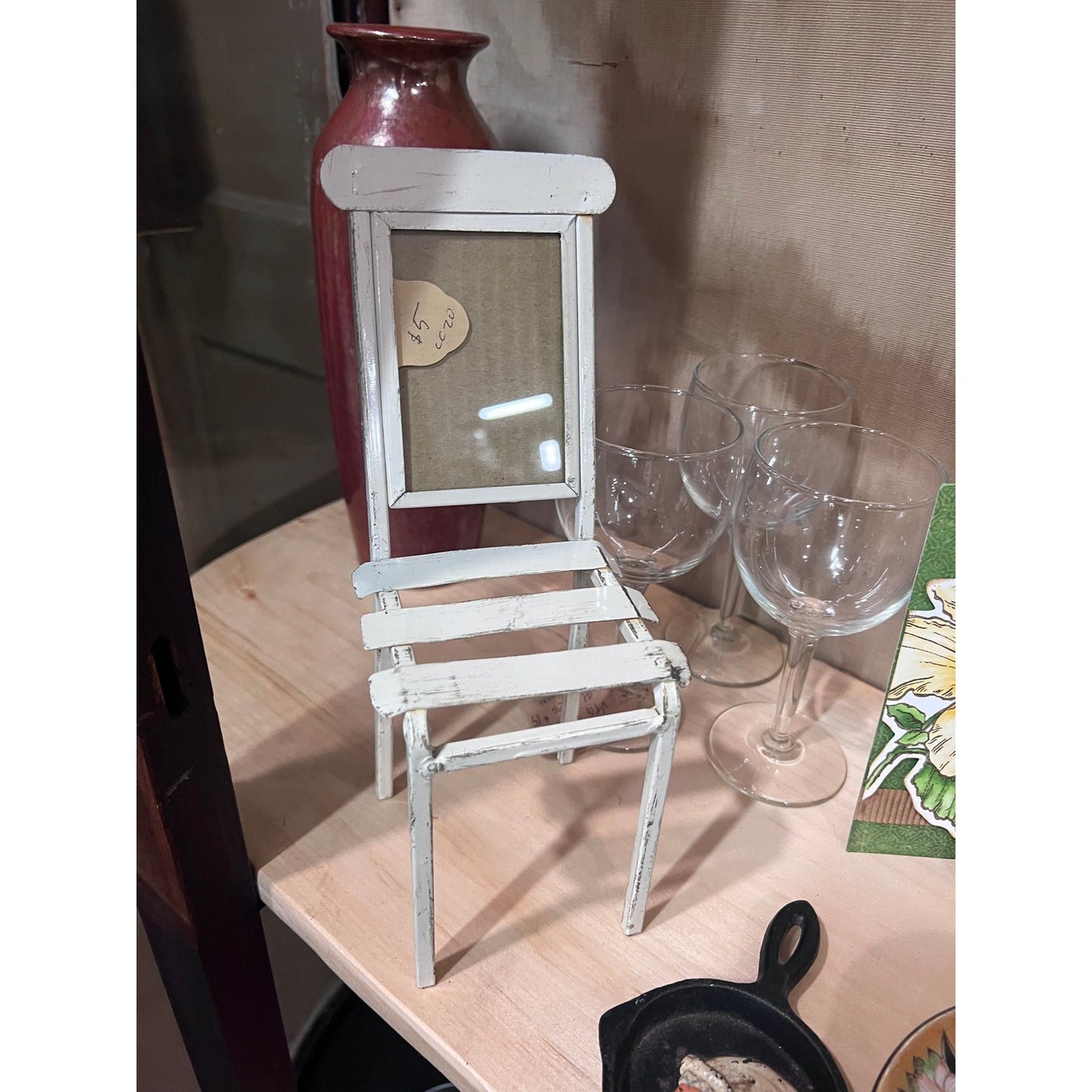 Metal chair with photo frame, acts as a shelf